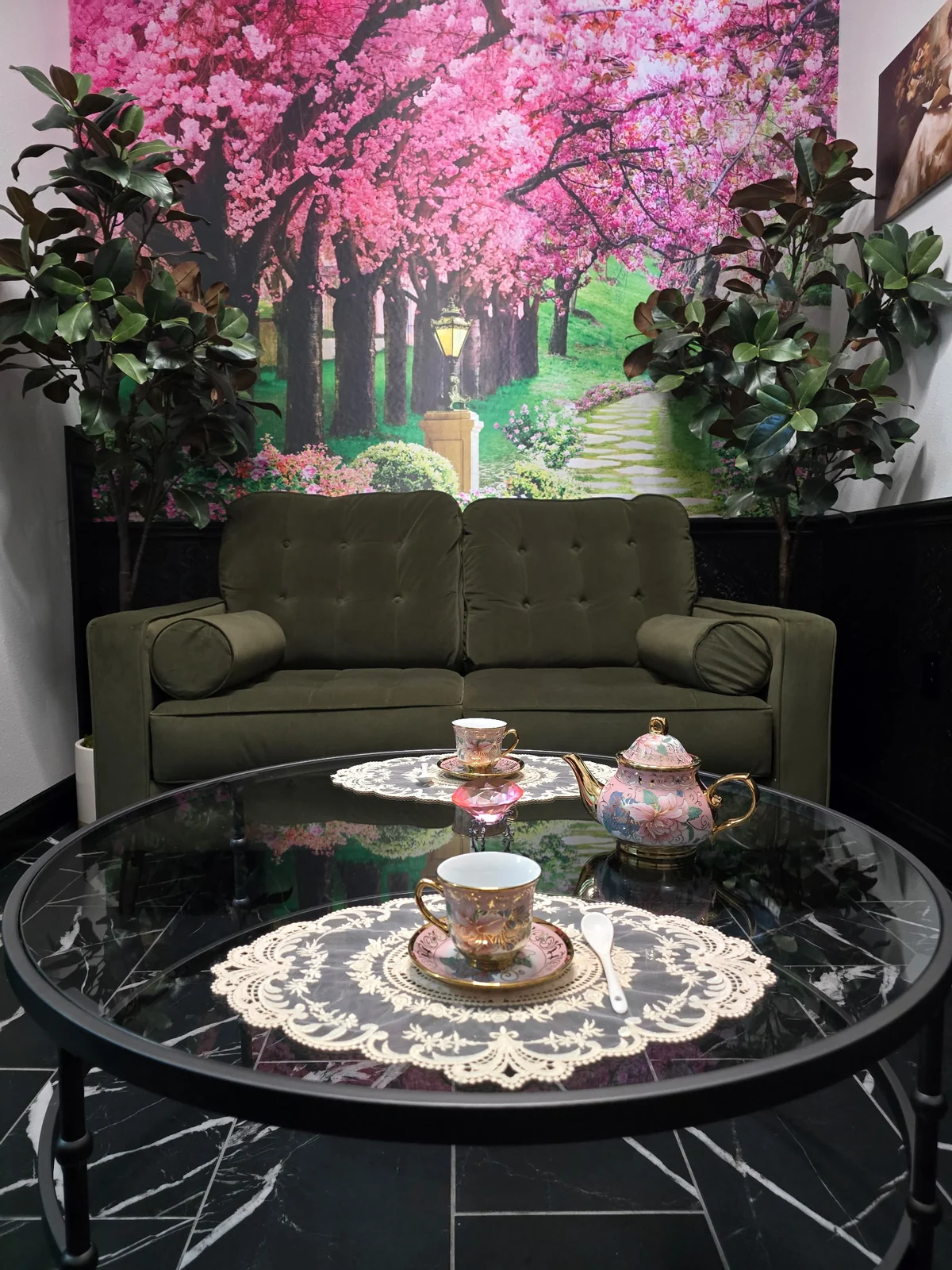 Private Tea Room with a floral mural, sofa, and set tea table