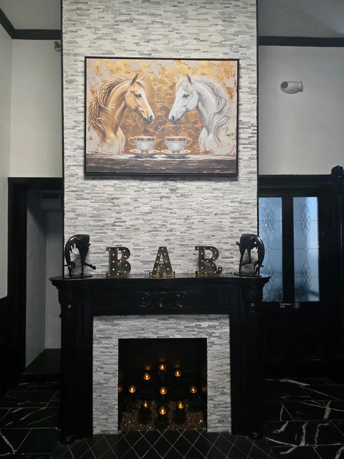 Fireplace and equestrian artwork inside the Diamond Suites building