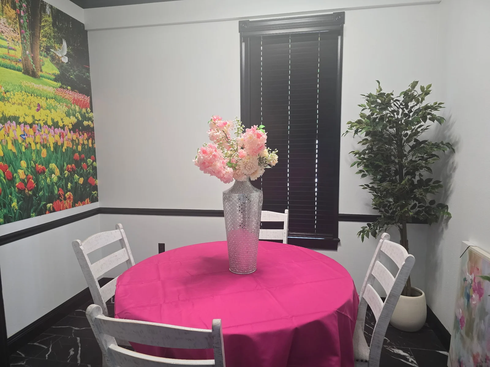 Private Tea Room table with flowers and a garden mural