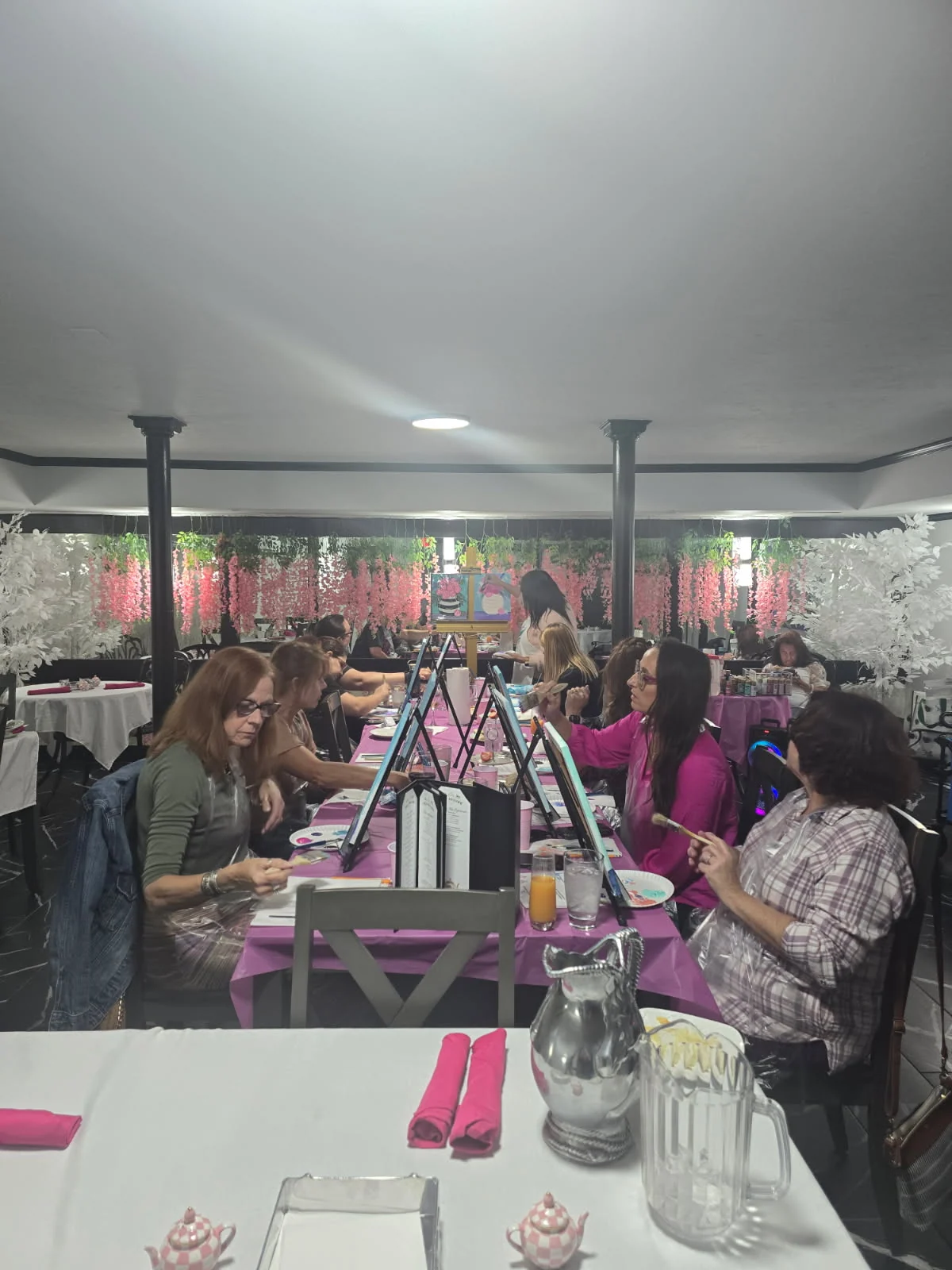 Guests seated together during a painting party